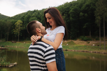 Beautiful couple walking in the park near the lake