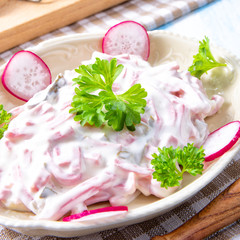 delicious homemade meat salad with mayonnaise and cucumber