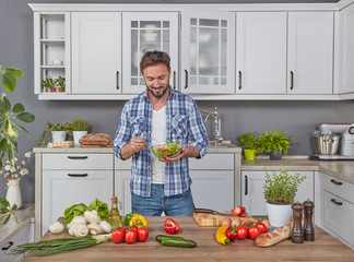 Handsome man preparing a salad