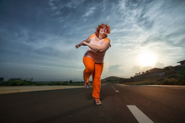Fototapeta na wymiar Beautiful young fat woman is runing