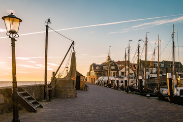 harbor of urk netherlands during sunset on a cold autumn day in Urk Flevoland  - obrazy, fototapety, plakaty