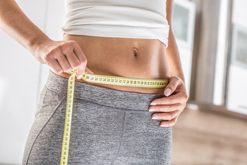 The sport figure of a attractive woman with measure tape