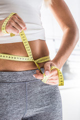The sport figure of a attractive woman with measure tape
