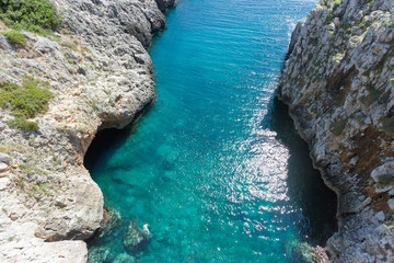 Apulia, Leuca, Grotto of Ciolo - A man swimming at Grotto Ciolo