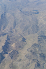 Fototapeta premium Aerial view of dry desert and the Andes Mountains somewhere over South America
