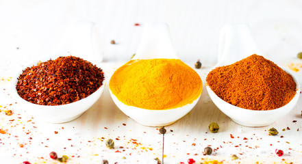 Spices in Wooden spoon. Herbs. Curry, Saffron, turmeric, rosemary, cinnamon, garlic, pepper, anise...