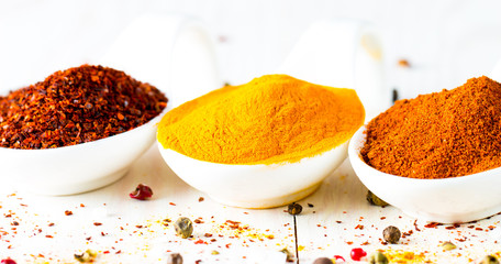 Spices in Wooden spoon. Herbs. Curry, Saffron, turmeric, rosemary, cinnamon, garlic, pepper, anise on wooden rustic background. Collection of spices and herbs. Salt, paprika. Copy space. 