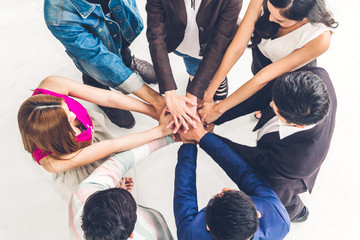 Top view of successful of group business people stack and putting their hands together at office.Friendship teamwork concept