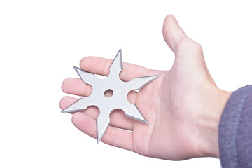 metal shuriken ninja in right hand isolate on white background