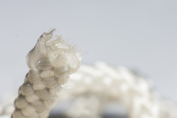 The tip of a white rope is macro, soft focus