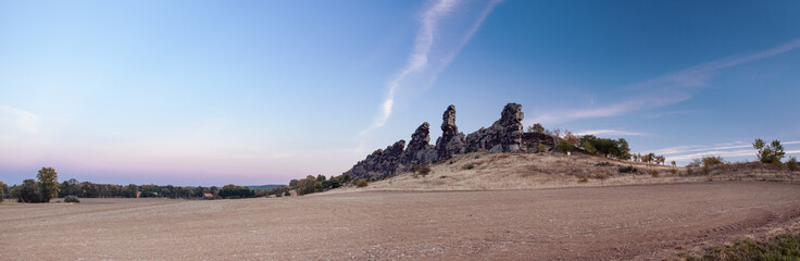 Giant mountain rock hills at beautiful sunset light. Sandstone rock formation Teufelsmauer (Devil's Wall) in Blankenburg, National park Harz in Germany, Harz Mountains.