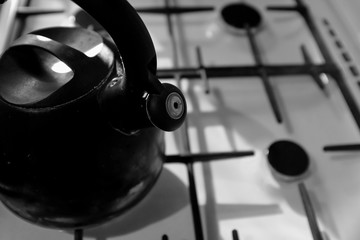 Old kettle on the gas stove in the kitchen