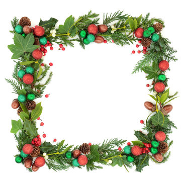 Abstract Christmas and winter square wreath garland with fir leaf sprigs, holly berries, ivy, mistletoe, bauble decorations, laurel, pine cones and acorns on white background with copy space.