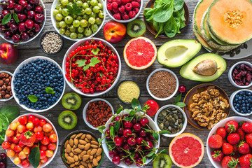 Healthy food on table. Breakfast in a bowls with assorted superfood, vegetarian diet with fruits, nuts and berries.