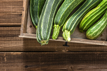 Fresh zucchini, green vegetables on local farmer market, freshly harvested courgette, summer squash
