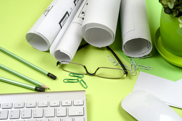 Workplace of architect - rolls and plans. Construction background.