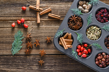 Decoration with christmas spice, background. Sweet spices for baking on wooden table - star anise, cinnamon stick, cardamom, nutmeg.