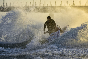 Silhouette of jet ski rider at Al Bateen Beach