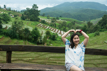 Fototapeta premium The pretty woman relaxing in holiday at rice terrace, Rice planting season in Chiang Mai, Tourism concept