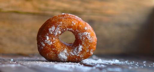 
fried donut covered with powdered sugar

