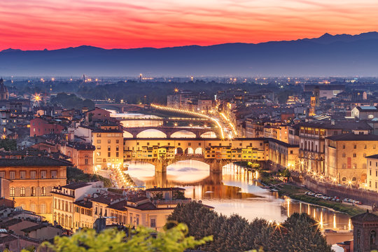Scenic panorama view on Ponte Vecchio in Florence, Italy, at sunset.