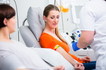 Nurse in hospital disinfecting puncture point before blood donation