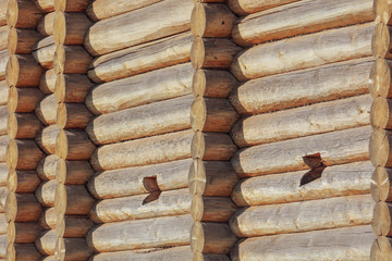 Wall with log house in the house as a background