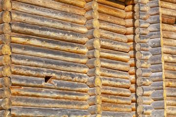 Wall with log house in the house as a background