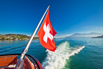 Switzerland flag on boat flowing Luzern lake