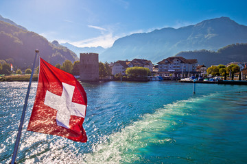 Lake Luzern boat flowing from Stansstad village with Swiss flag