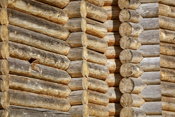 Wall with log house in the house as a background