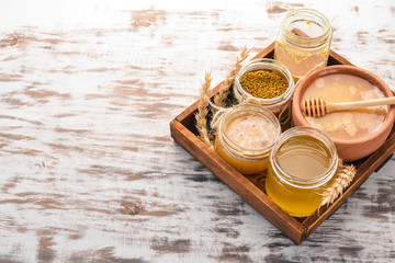 Set honey in a wooden box on a wooden background. Free space for text. Top view.