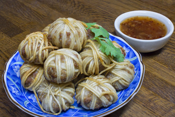 Mhoo sarong  (Deep fried wrapped pork ball with noodle) menu is Thai food. Made from grated pork wrapped in vermicelli. This image was taken before frying.
