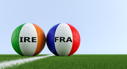 Ireland vs. France Soccer Match - Soccer balls in Ireland and France national colors on a soccer field. Copy space on the right side - 3D Rendering