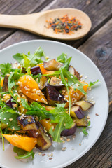 Salad baked eggplant and fresh tomatoes and arugula