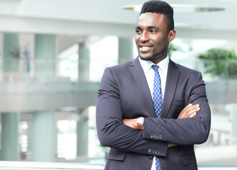 Fototapeta premium Successful African American businessman businessman standing in office.