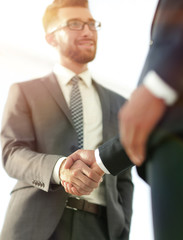 Friendly smiling businessmen handshaking. Business concept photo