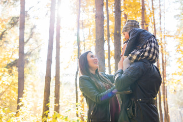 Parenthood, fall and people concept - young family happy in autumn park