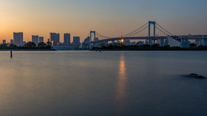 Fototapeta na wymiar Sunset view of Tokyo Bay, Tokyo city center and Rainbow bridge