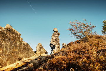 Panorama view of a rock wall landscape in beautiful colorful sunset light. Sandstone rock formation Teufelsmauer (Devil's Wall) in Blankenburg, National park Harz in Germany, Harz Mountains.