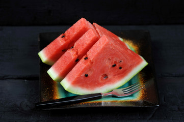 watermelon pieces in a black bowl