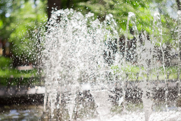 Splash of fountain in the spring or summer park. Water splash