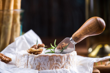 Cutting camembert cheese with cheese knife