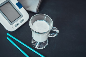 White electric tonometer and glass of kefir