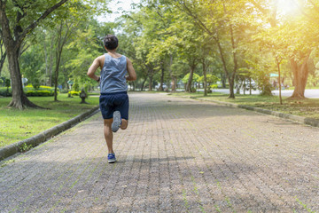 Fototapeta premium Sporty man jogging or exercise in national park on early morning .Sport concept.