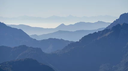 Poster Landscape on hills and Alps mountains with humidity in the air and pollution. Panorama from Farno Mountain, Bergamo, Italy © Matteo Ceruti