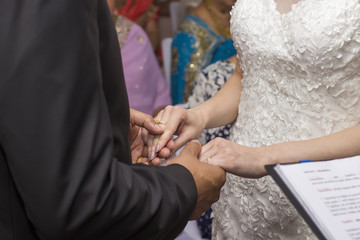 Obraz na płótnie Canvas Groom and bride holding hands at wedding ceremony