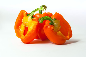 Orange fresh pepper on white  background. The concept of  tasty and healthy meal, copy space, closeup.