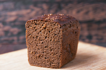 Black rye bread on a wooden background