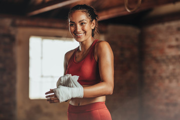Woman getting ready for boxing practice - Powered by Adobe